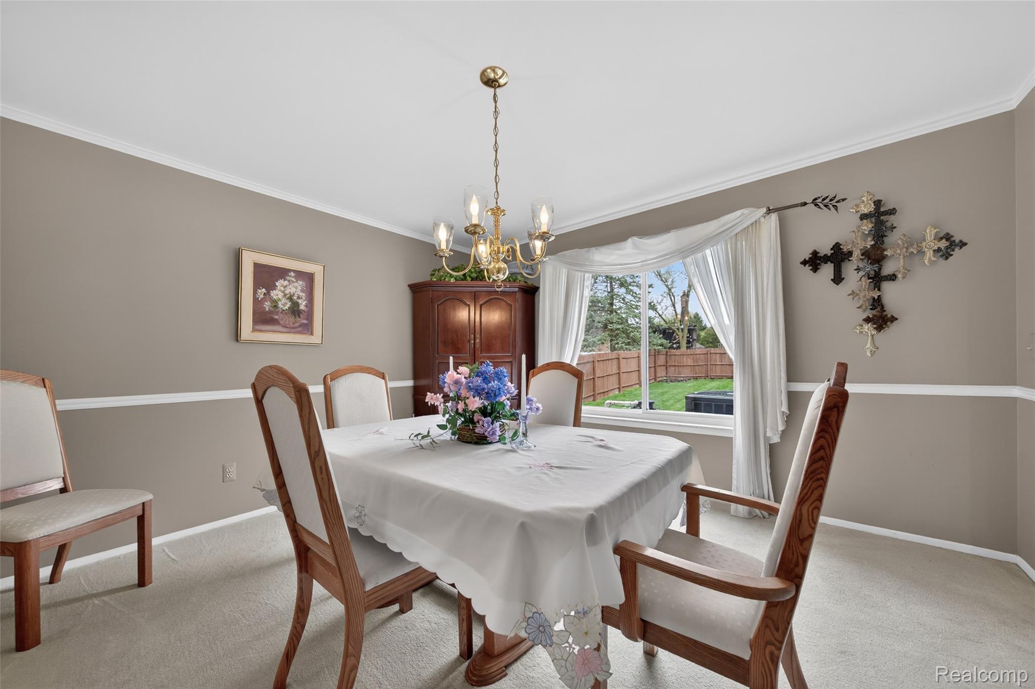 2578 Powderhorn Ridge Road Rochester, MI 48309 - Photo 9 of 46 Dining space with hanging lights, ornamental molding, and light carpet