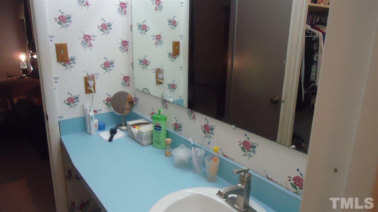 5409 Old Forge Circle Raleigh, NC 27609 - Photo 15 of 19 a bathroom with a sink a toilet and shower curtain