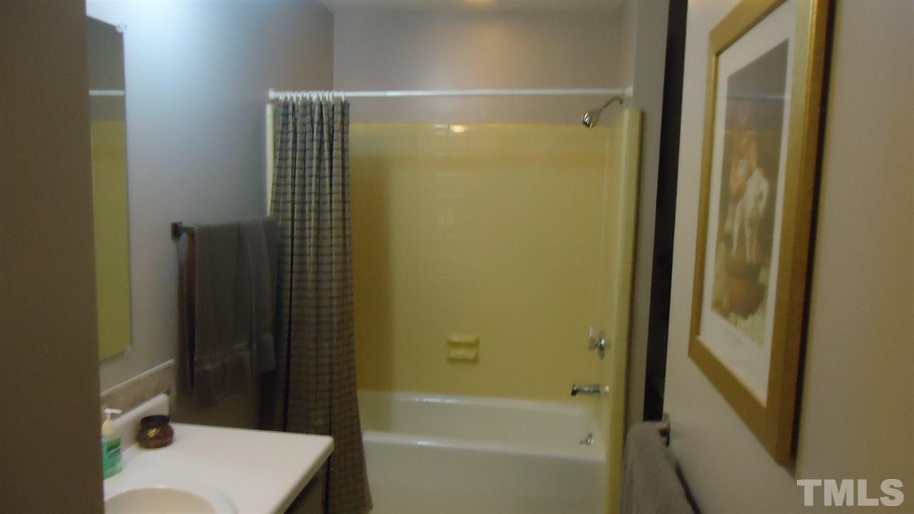 5409 Old Forge Circle Raleigh, NC 27609 - Photo 17 of 19 a bathroom with a shower and a toilet