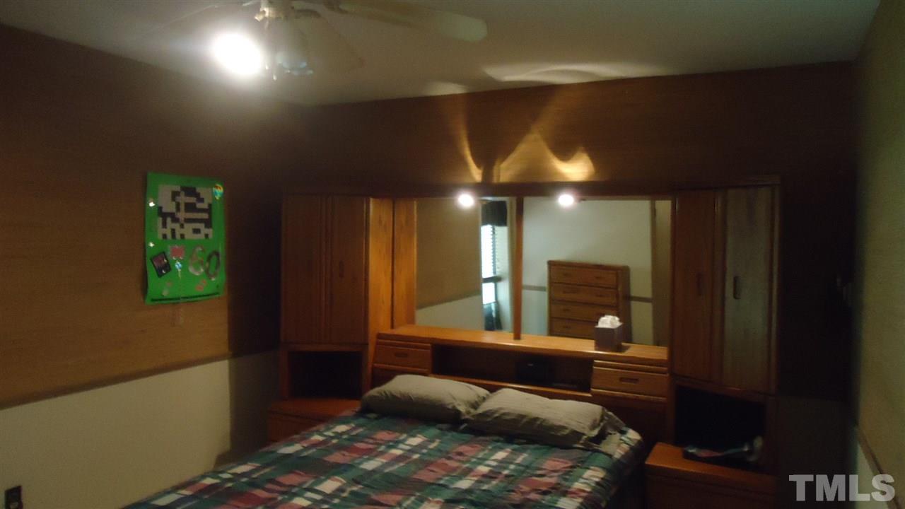 5409 Old Forge Circle Raleigh, NC 27609 - Photo 18 of 19 a bedroom with a bed window and a potted plant