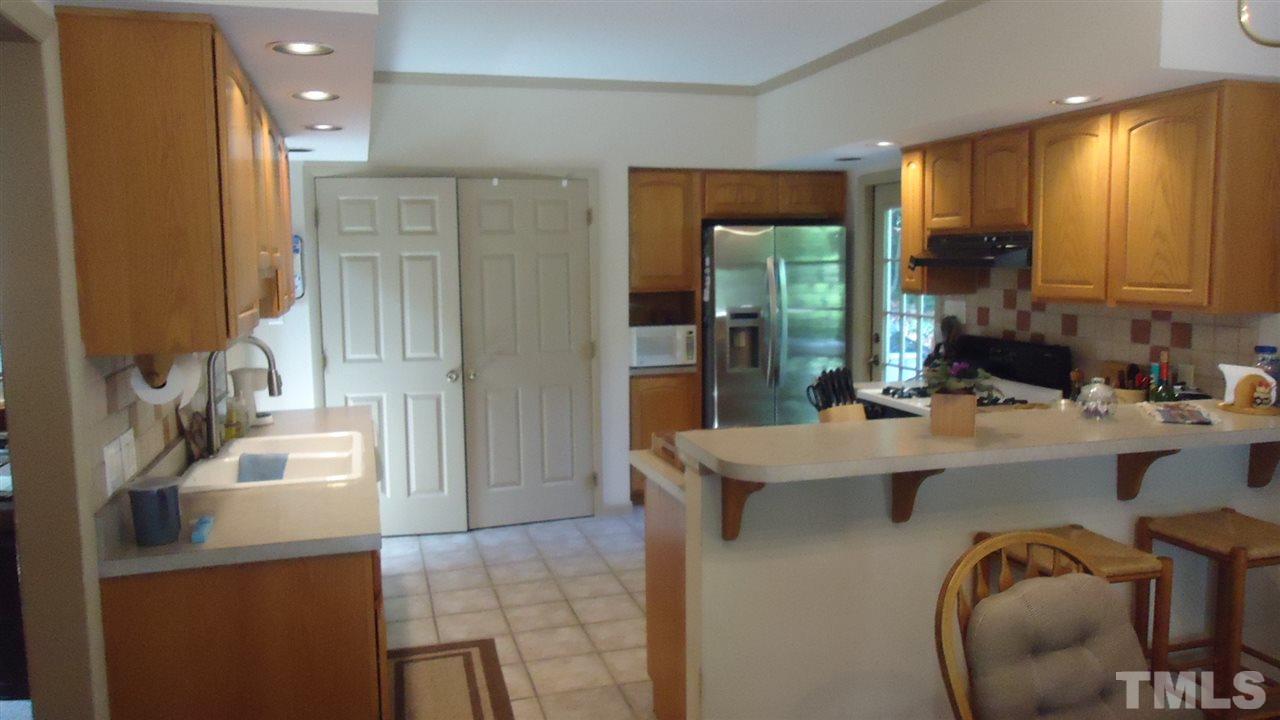 5409 Old Forge Circle Raleigh, NC 27609 - Photo 5 of 19 a kitchen with a sink appliances and cabinets