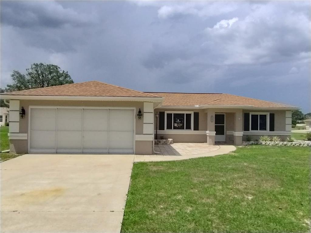 9833 Southwest 61st Court Ocala, FL 34476 - Photo 1 of 14 a front view of a house with a yard and garage