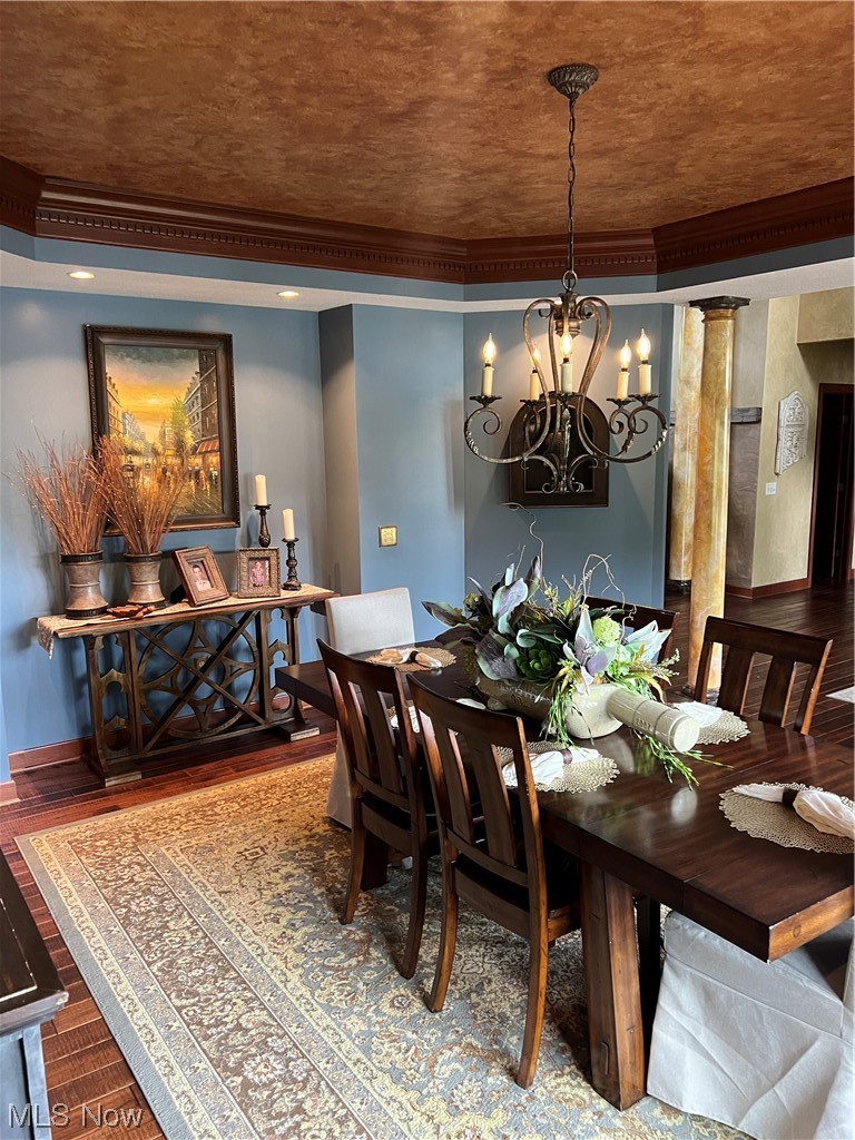 1457 Terrace Road Northwest New Philadelphia, OH 44663 - Photo 12 of 33 Dining room with a chandelier, dark wood-type flooring, and crown molding