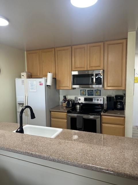 101 Shell Road, Unit 247 Watsonville, CA 95076 - Photo 9 of 11 a kitchen with a refrigerator sink and white cabinets