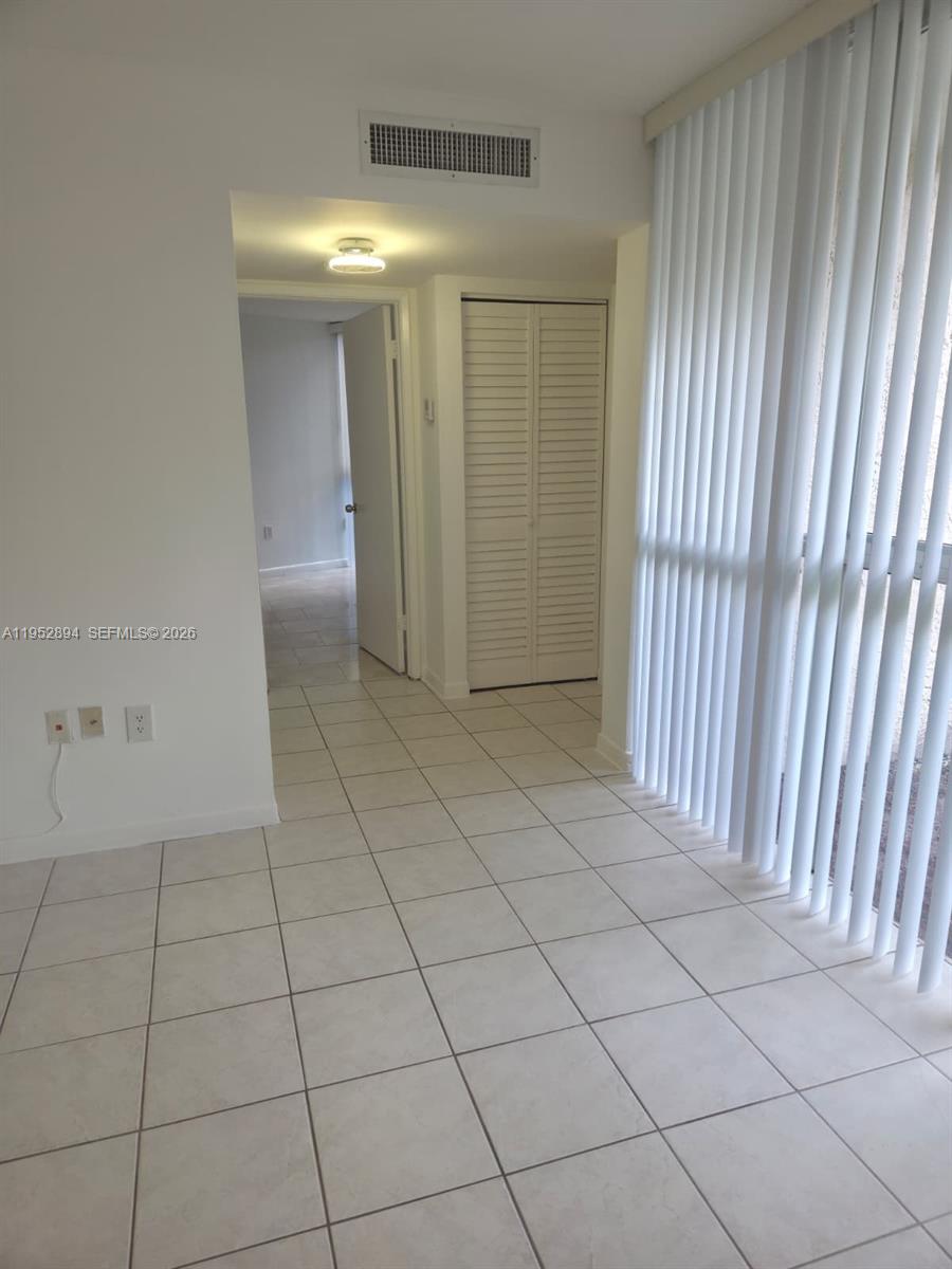 7075 Northwest 186th Street, Unit C104 Hialeah, FL 33015 - Photo 11 of 24 a view of a livingroom with an entryway