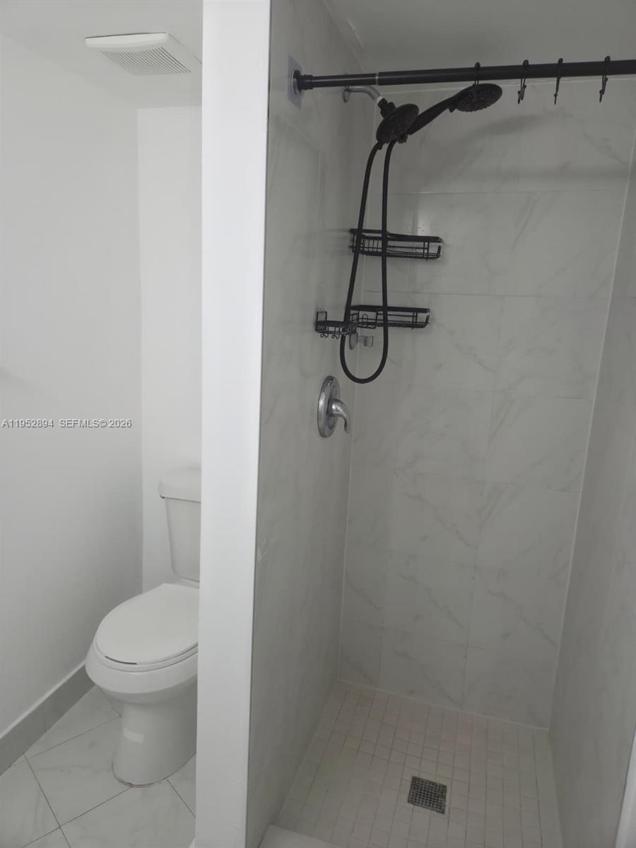 7075 Northwest 186th Street, Unit C104 Hialeah, FL 33015 - Photo 14 of 24 a white toilet sitting next to a shower
