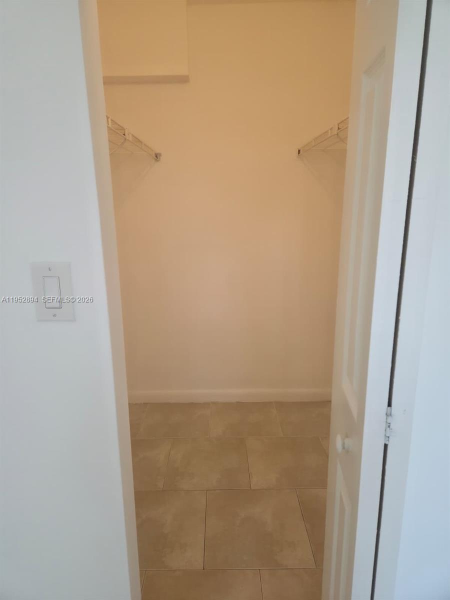 7075 Northwest 186th Street, Unit C104 Hialeah, FL 33015 - Photo 17 of 24 a bathroom with a glass shower door
