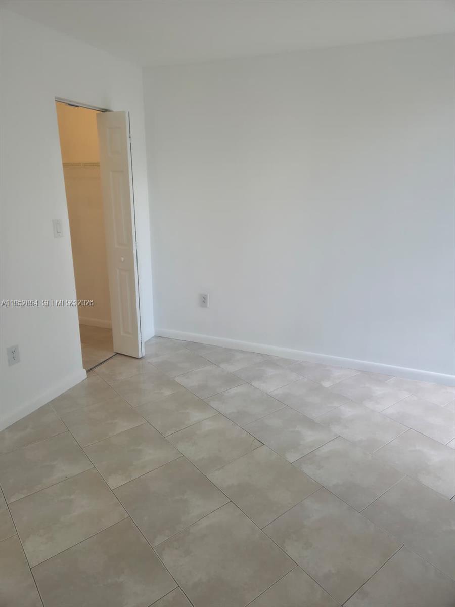 7075 Northwest 186th Street, Unit C104 Hialeah, FL 33015 - Photo 20 of 24 a view of an empty room