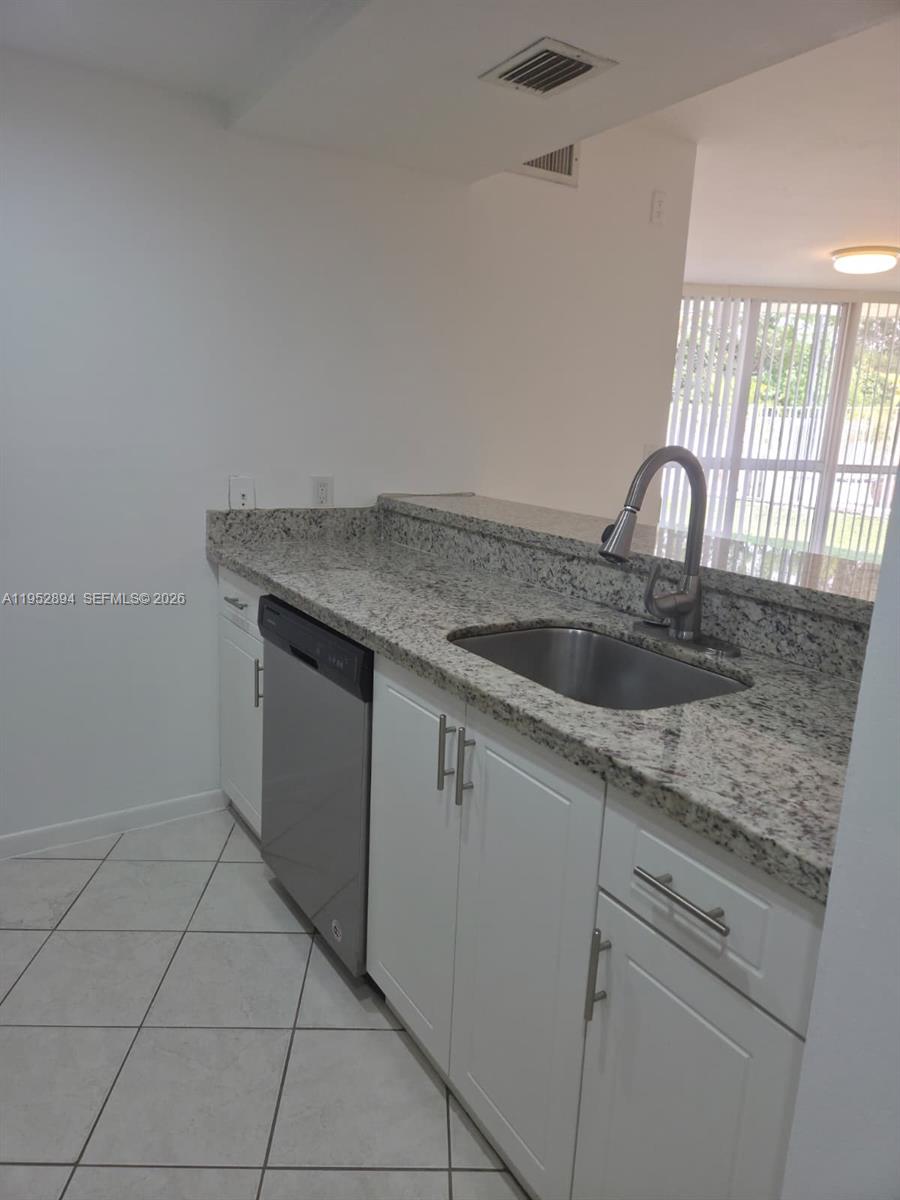 7075 Northwest 186th Street, Unit C104 Hialeah, FL 33015 - Photo 5 of 24 a close view of sink and tap
