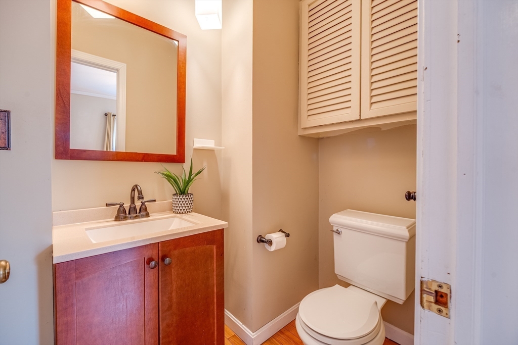 13 Finn Street Northampton, MA 01060 - Photo 25 of 40 a bathroom with a toilet a sink a mirror and vanity