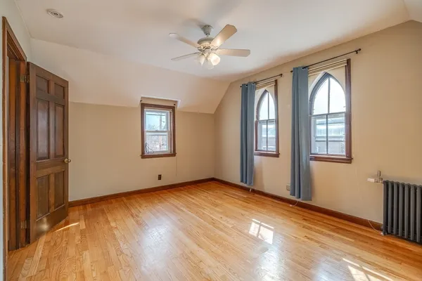 an empty room with wooden floor and closet