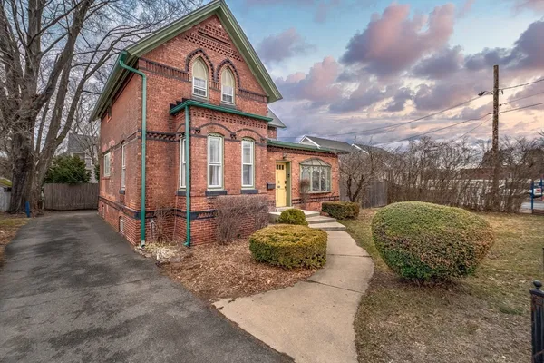 a room with a table chairs and a large window