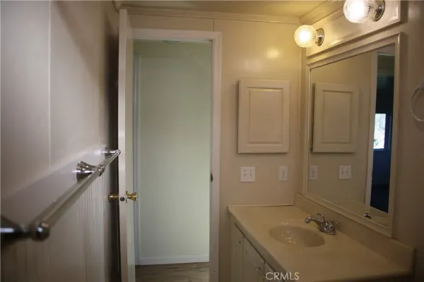 wooden bathroom with a sink and mirror