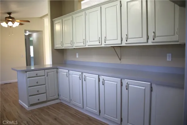 a kitchen with granite countertop white cabinets and sink