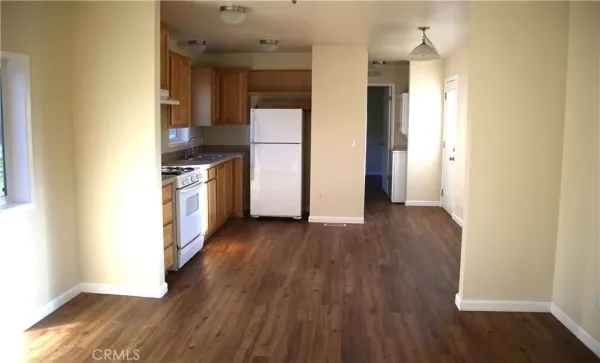 a kitchen with granite countertop wooden floors and stainless steel appliances