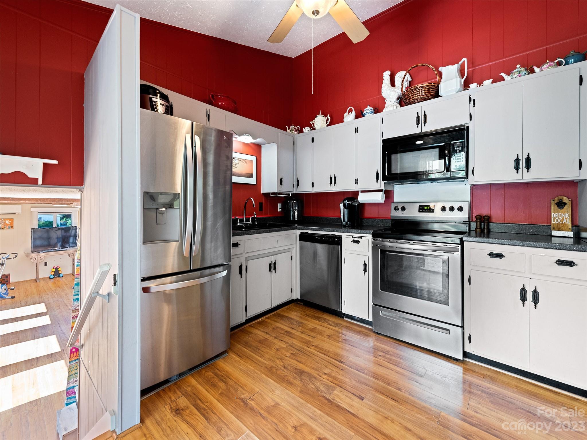 69 Patton Cemetery Road Swannanoa, NC 28778 - Photo 15 of 35 a kitchen with stainless steel appliances and white cabinets