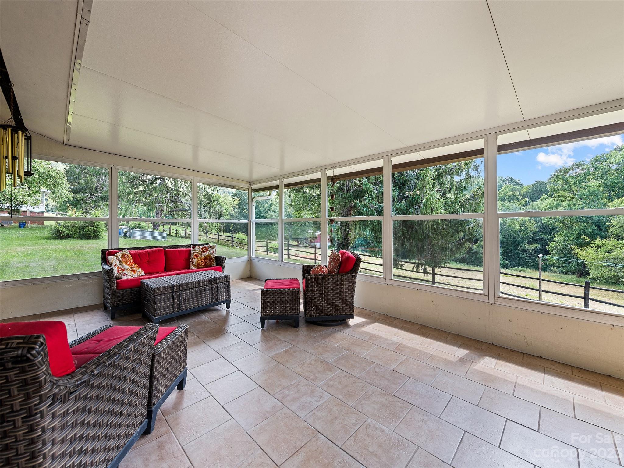 69 Patton Cemetery Road Swannanoa, NC 28778 - Photo 18 of 35 a living room with couch and a floor to ceiling window