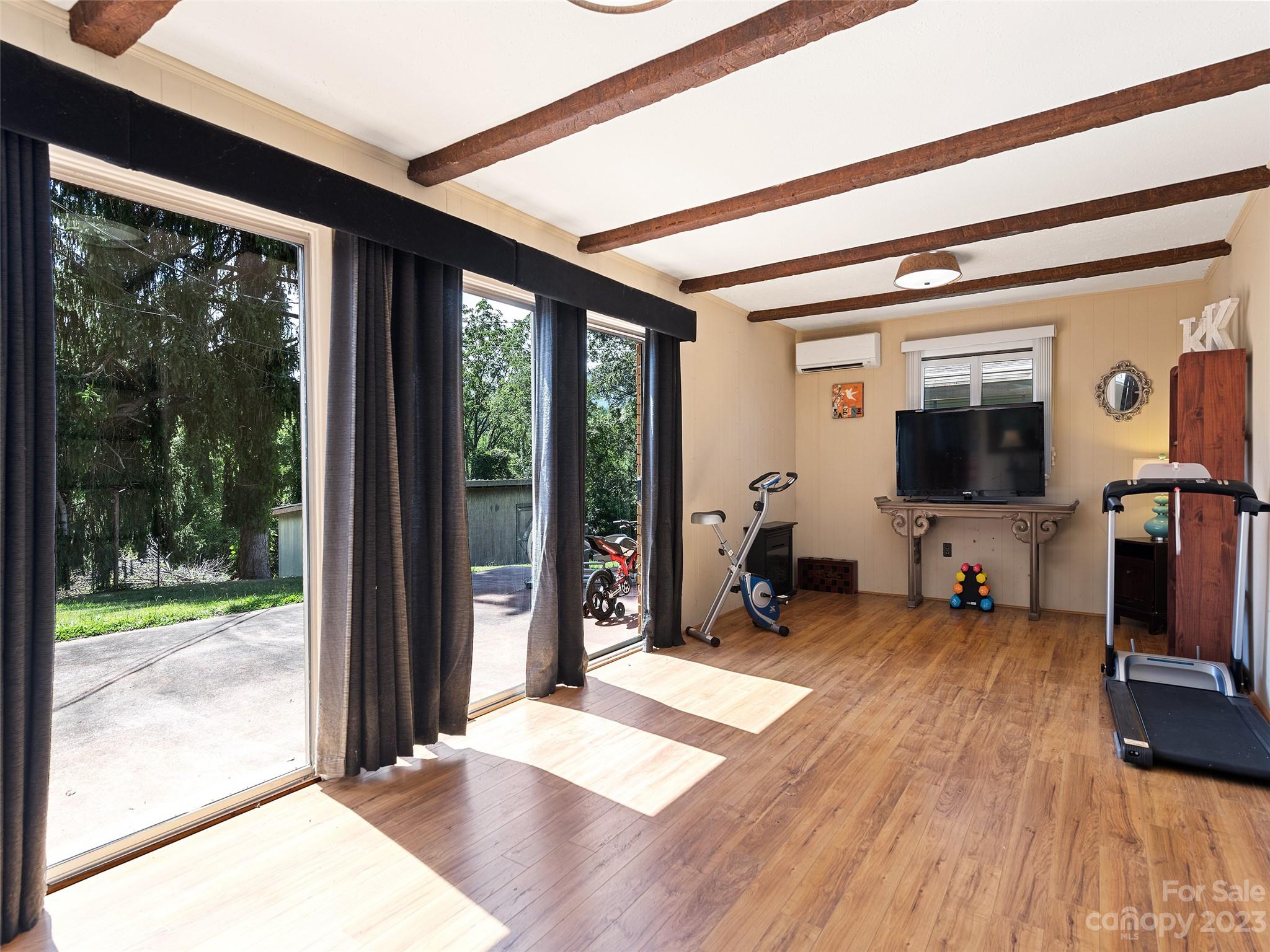 69 Patton Cemetery Road Swannanoa, NC 28778 - Photo 20 of 35 a living room with hardwood floor and a large window