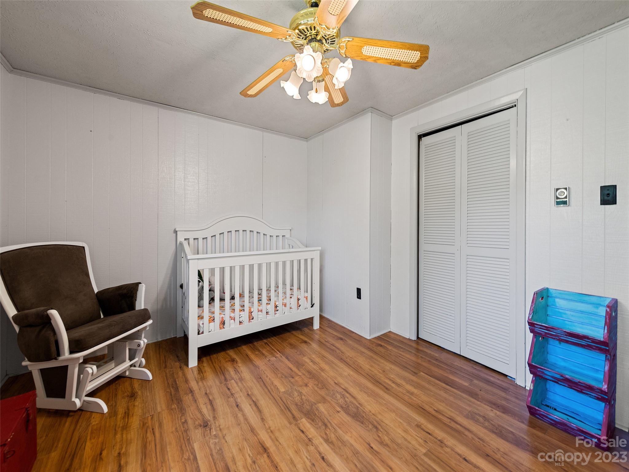 69 Patton Cemetery Road Swannanoa, NC 28778 - Photo 24 of 35 a bedroom with a bed and wooden floor