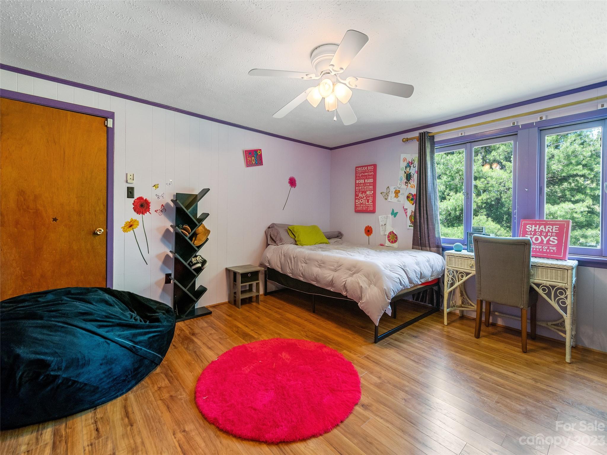 69 Patton Cemetery Road Swannanoa, NC 28778 - Photo 25 of 35 a bedroom with a bed and a chandelier