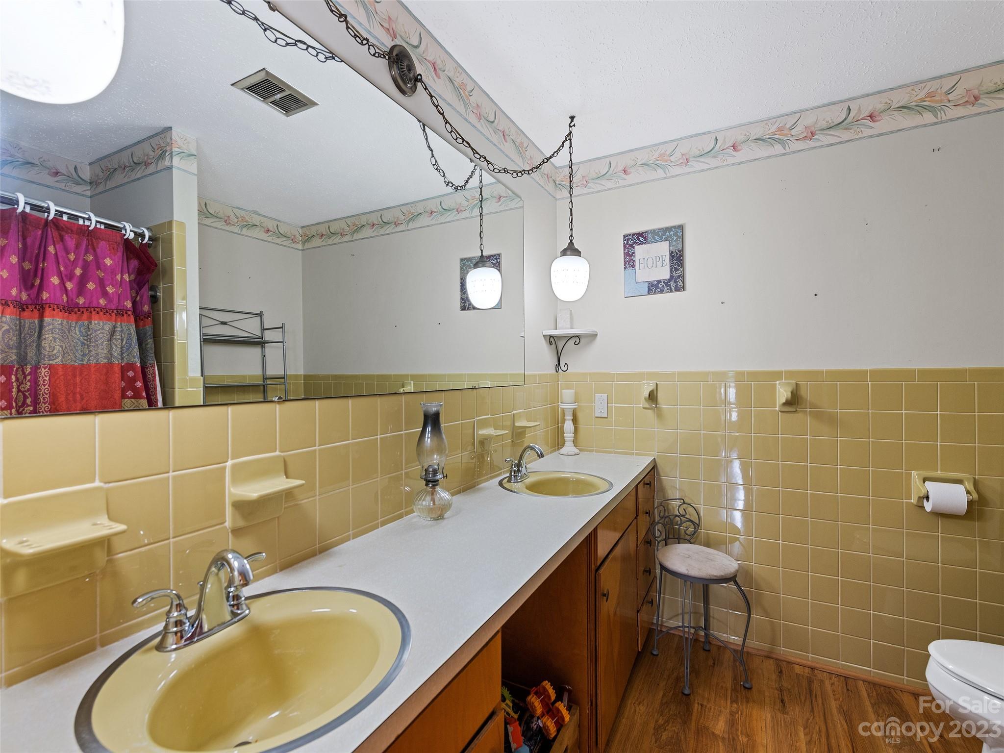 69 Patton Cemetery Road Swannanoa, NC 28778 - Photo 27 of 35 a bathroom with a granite countertop sink a mirror and a toilet