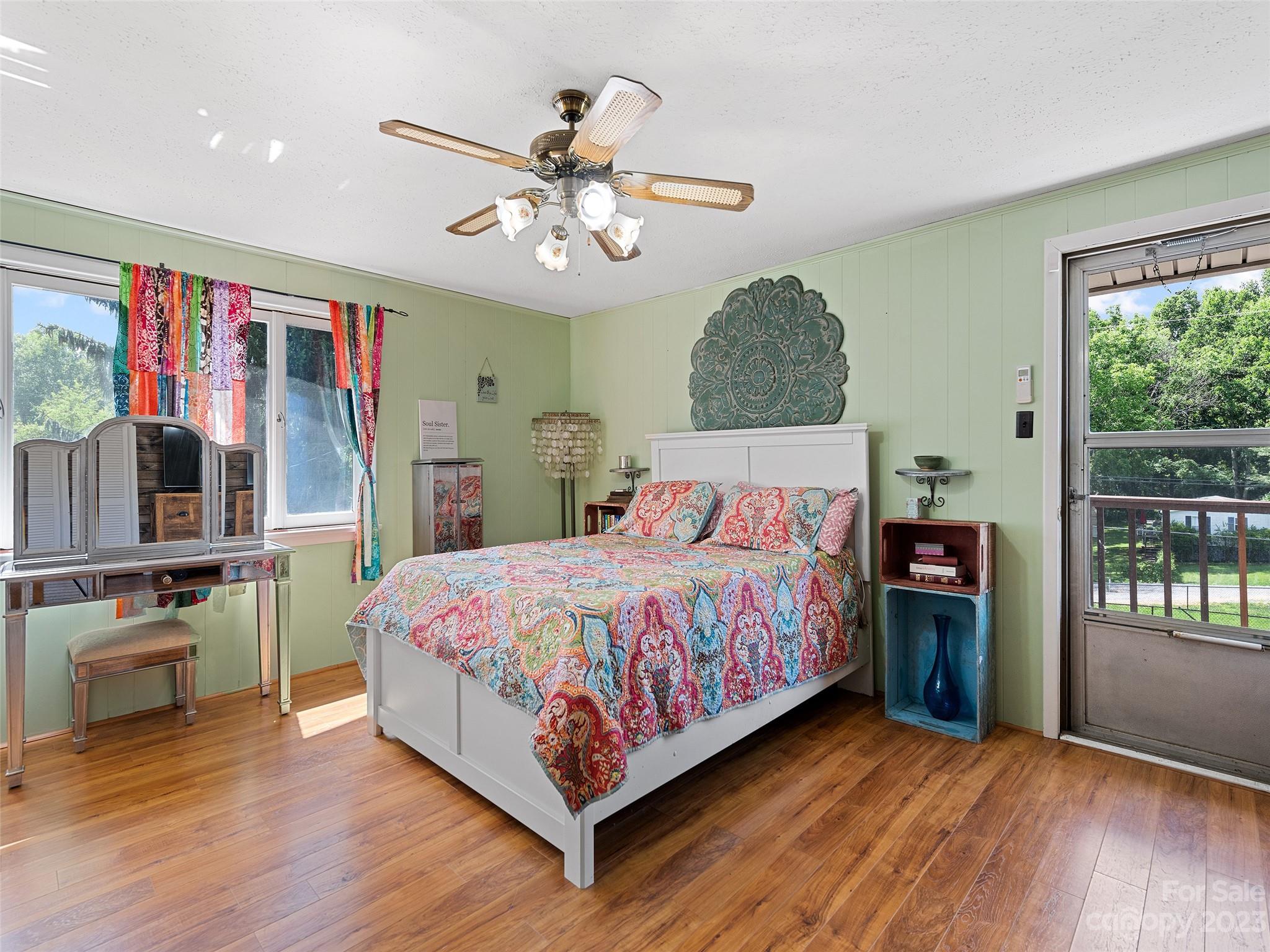 69 Patton Cemetery Road Swannanoa, NC 28778 - Photo 28 of 35 a bedroom with a large bed and a chandelier