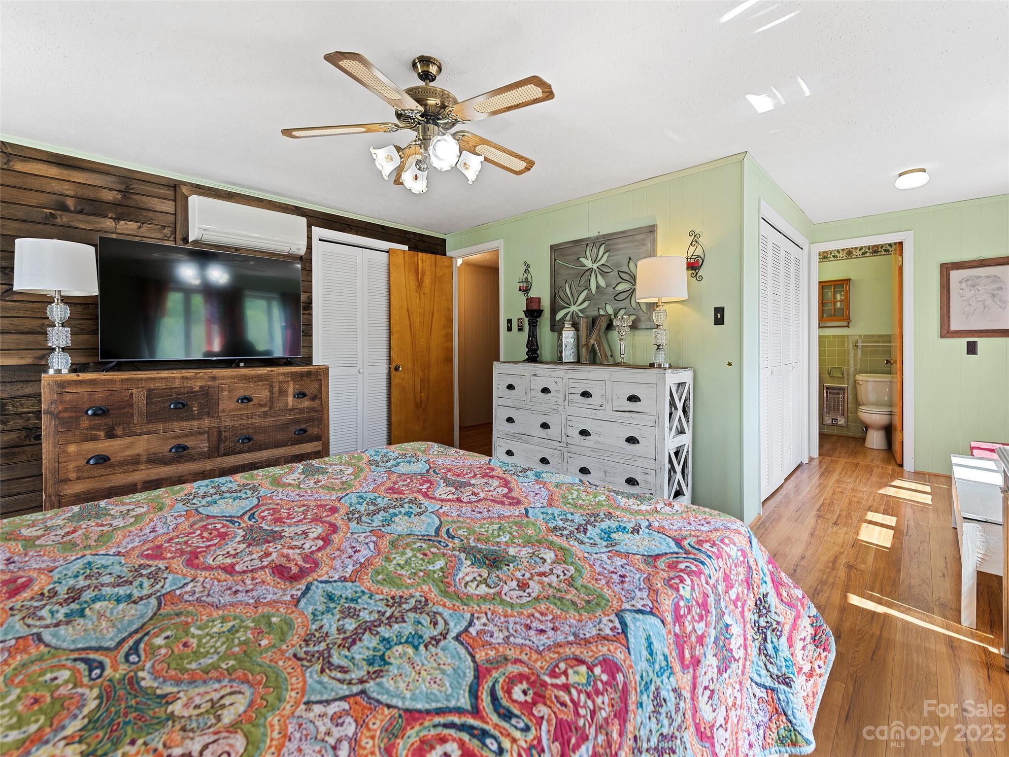 69 Patton Cemetery Road Swannanoa, NC 28778 - Photo 29 of 35 a bedroom with a bed and a flat screen tv