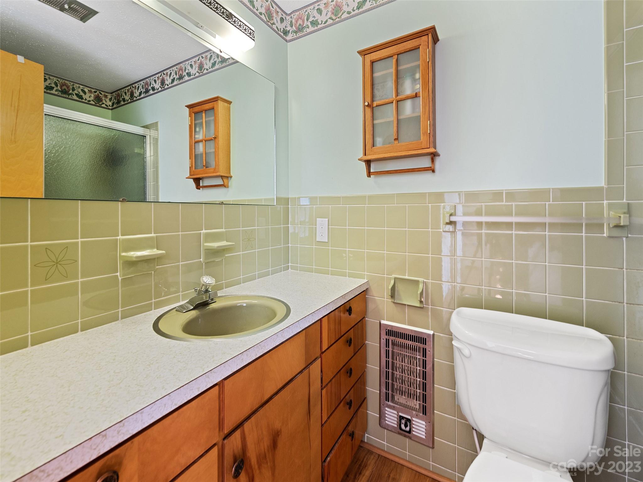 69 Patton Cemetery Road Swannanoa, NC 28778 - Photo 30 of 35 a bathroom with a sink a toilet and a mirror
