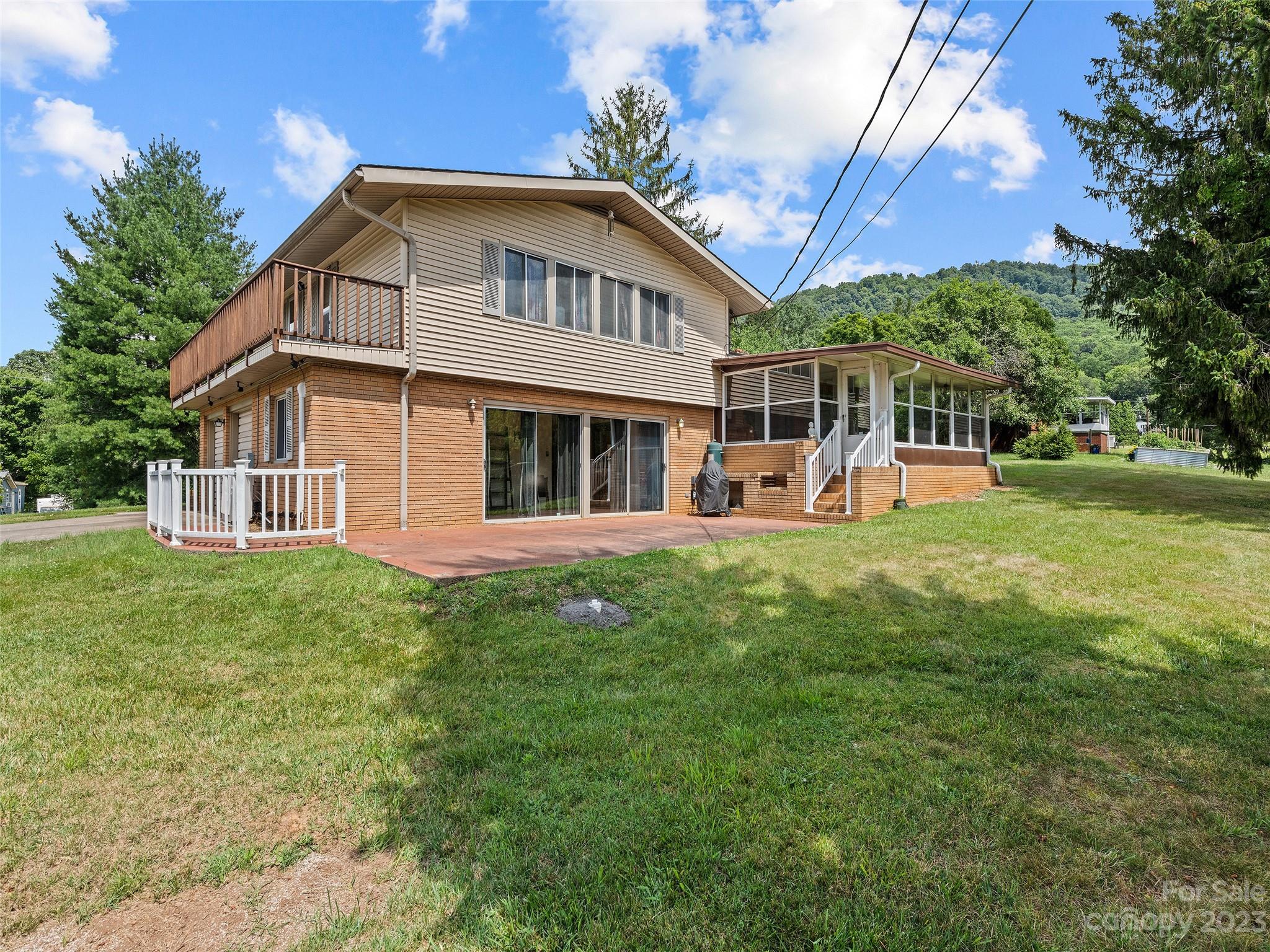 69 Patton Cemetery Road Swannanoa, NC 28778 - Photo 5 of 35 a front view of a house with a yard and trees