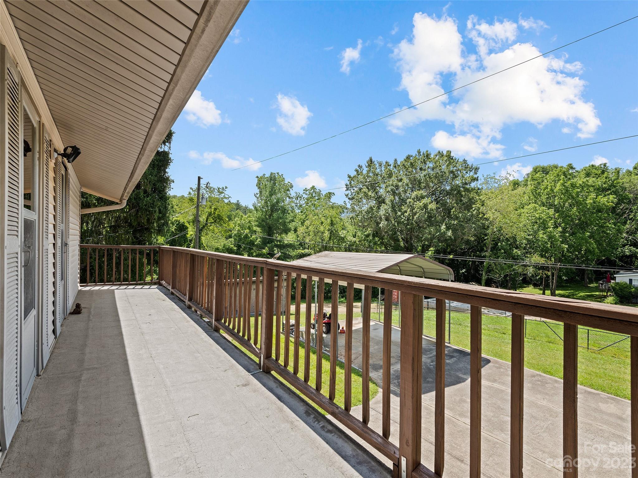 69 Patton Cemetery Road Swannanoa, NC 28778 - Photo 7 of 35 a balcony with wooden floor and fence