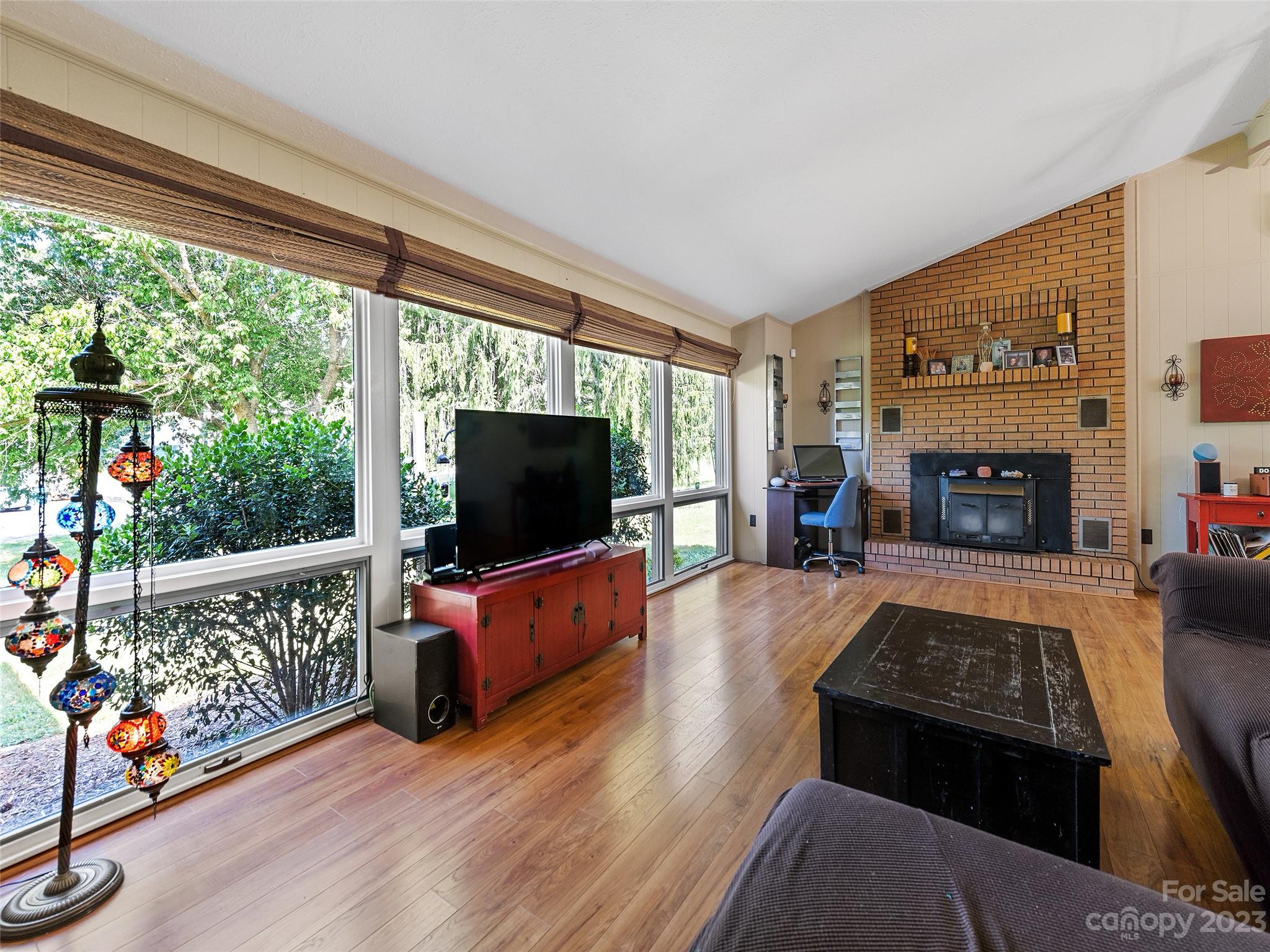 69 Patton Cemetery Road Swannanoa, NC 28778 - Photo 8 of 35 a living room with furniture a flat screen tv and a fireplace