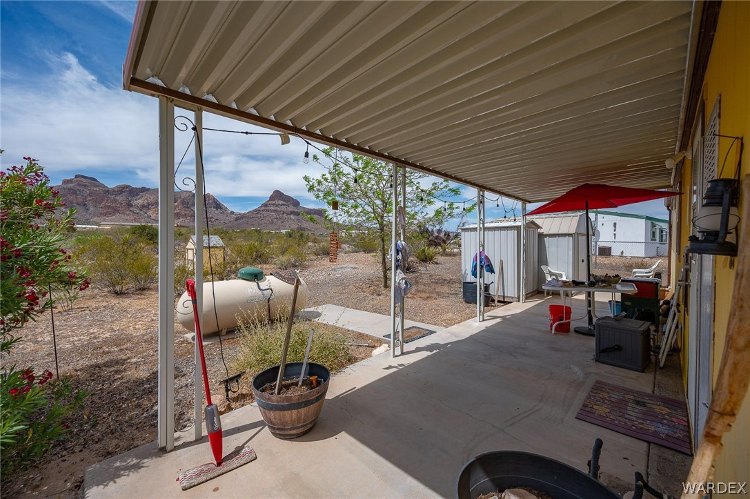 2465 Egar Road Golden Valley, AZ 86413 - Photo 38 of 98 The property includes a covered patio with a concrete floor, offering views of distant mountains