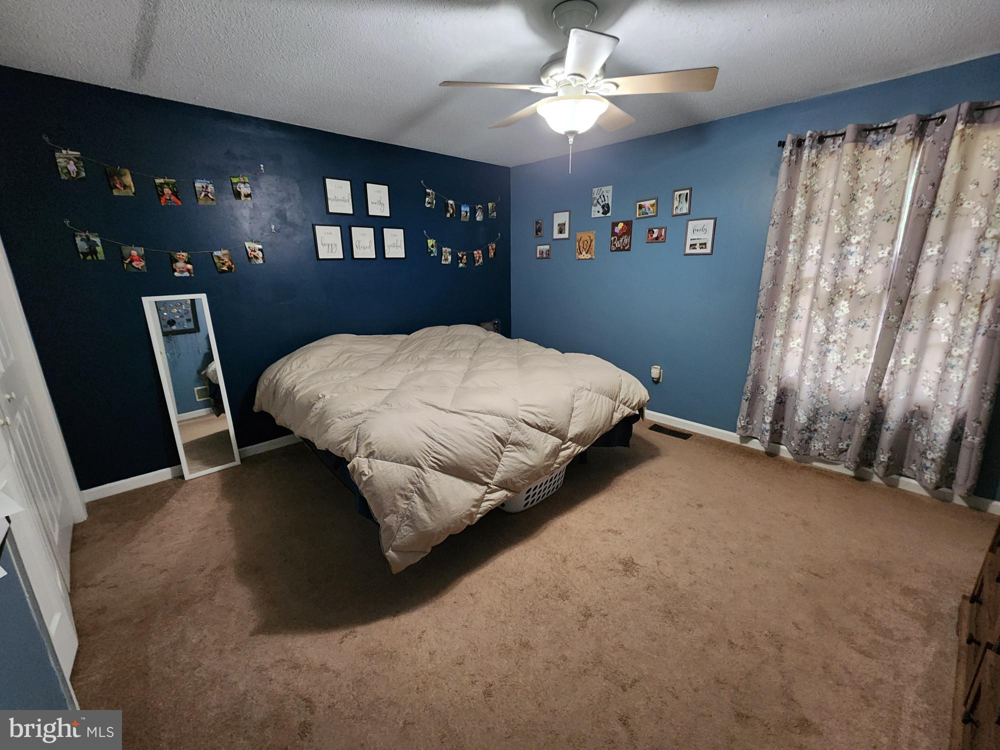87 Summers Street Inwood, WV 25428 - Photo 13 of 41 a bed sitting in a bedroom next to a window