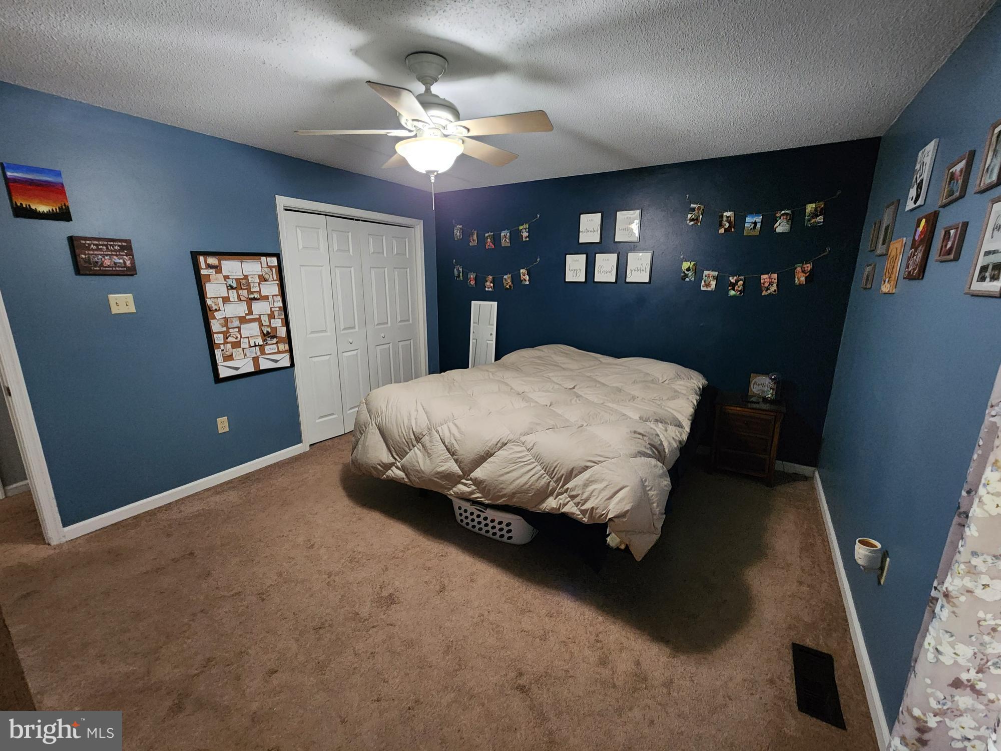 87 Summers Street Inwood, WV 25428 - Photo 15 of 41 a bedroom with a large bed chandelier and a window