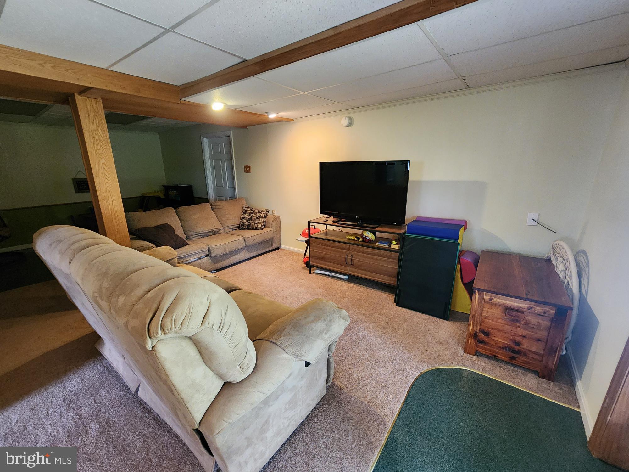 87 Summers Street Inwood, WV 25428 - Photo 22 of 41 a living room with furniture and a flat screen tv