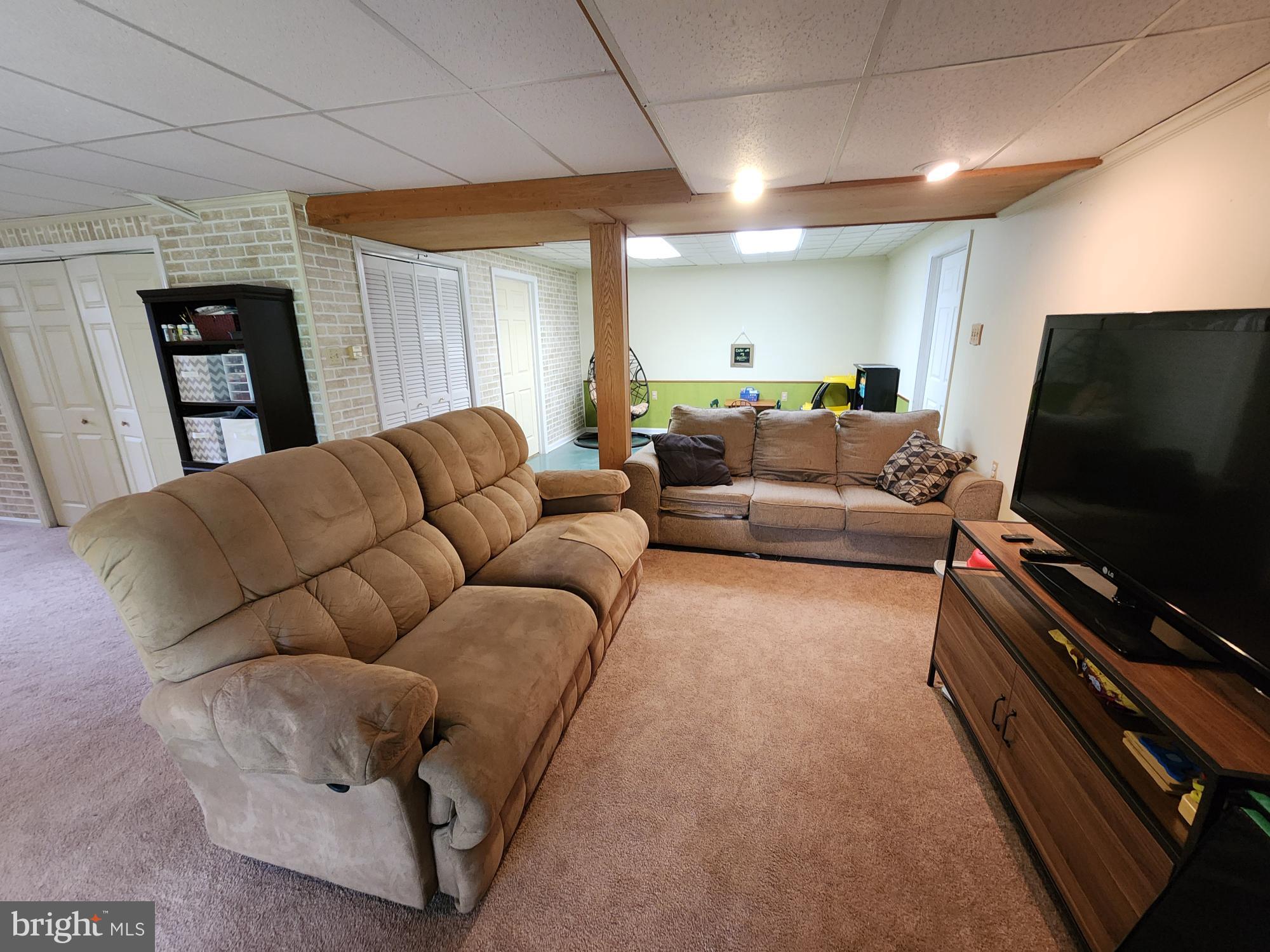 87 Summers Street Inwood, WV 25428 - Photo 23 of 41 a living room with furniture and a flat screen tv