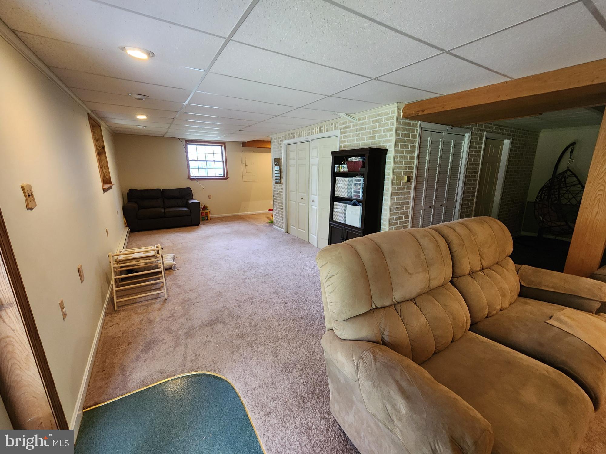87 Summers Street Inwood, WV 25428 - Photo 25 of 41 a living room with furniture and a flat screen tv