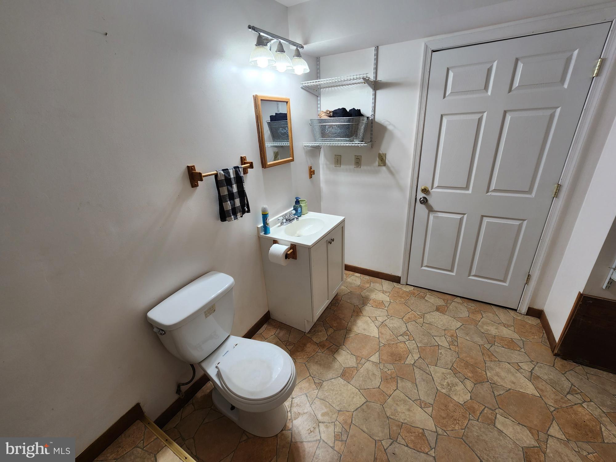 87 Summers Street Inwood, WV 25428 - Photo 30 of 41 a white toilet sitting next to a bathroom sink