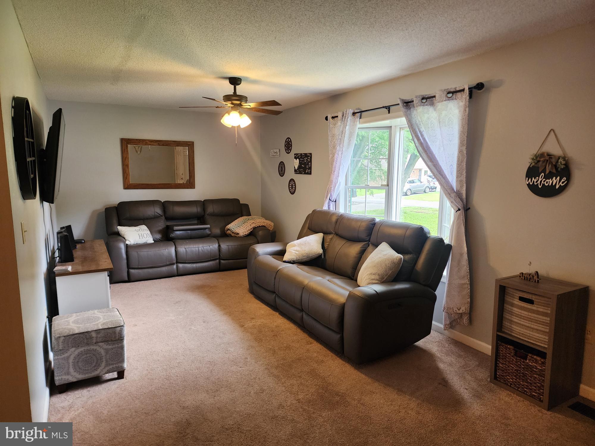 87 Summers Street Inwood, WV 25428 - Photo 3 of 41 a living room with furniture a flat screen tv and a window