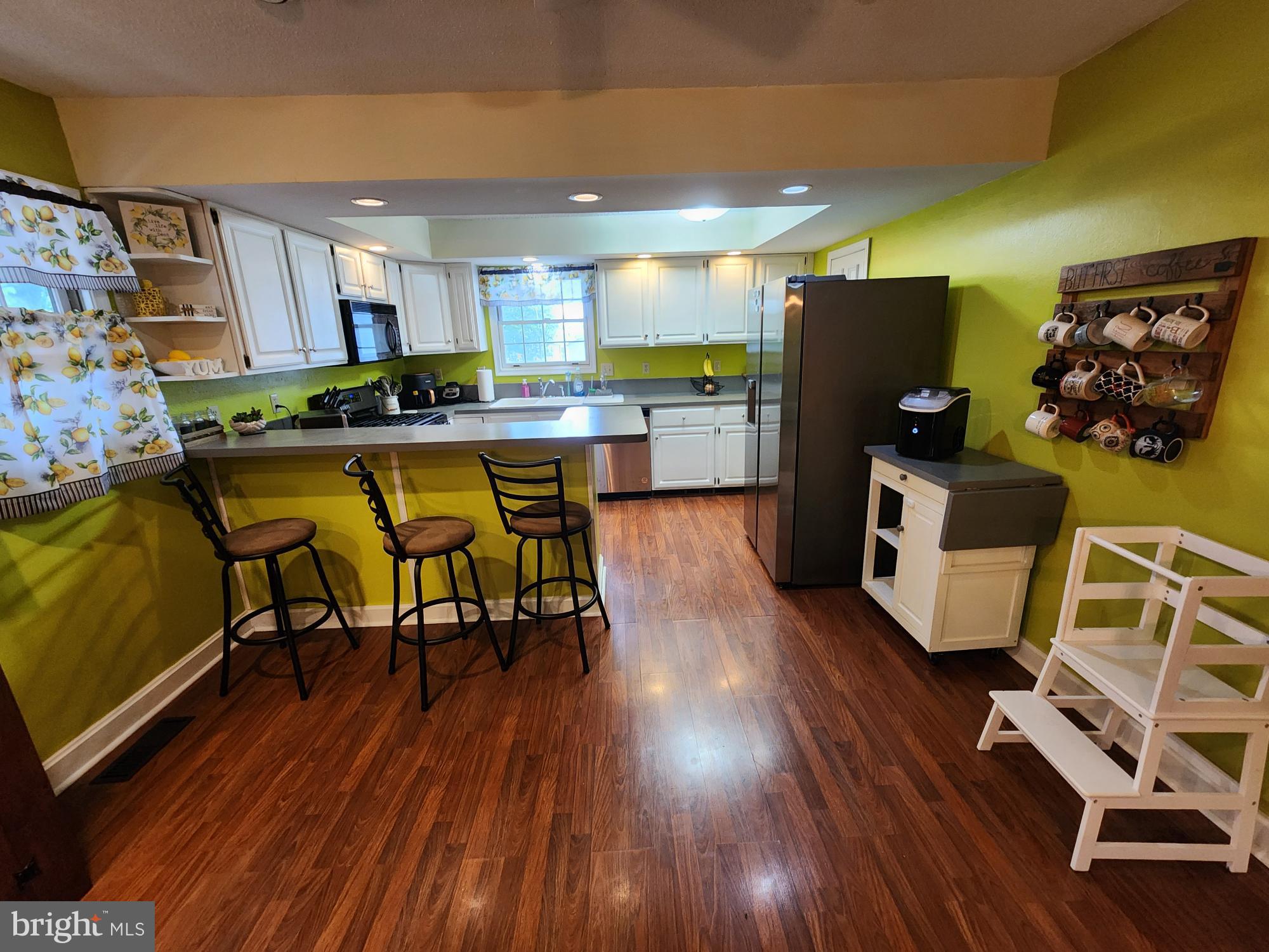 87 Summers Street Inwood, WV 25428 - Photo 8 of 41 a kitchen with stainless steel appliances wooden floors and view living room