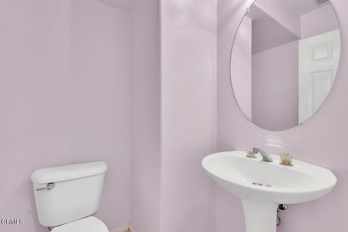 825 Noontide Way Oxnard, CA 93035 - Photo 11 of 26 a bathroom with a toilet a sink and mirror