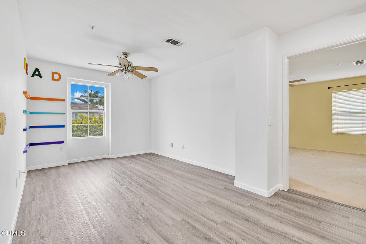 825 Noontide Way Oxnard, CA 93035 - Photo 12 of 26 wooden floor in an empty room with a window