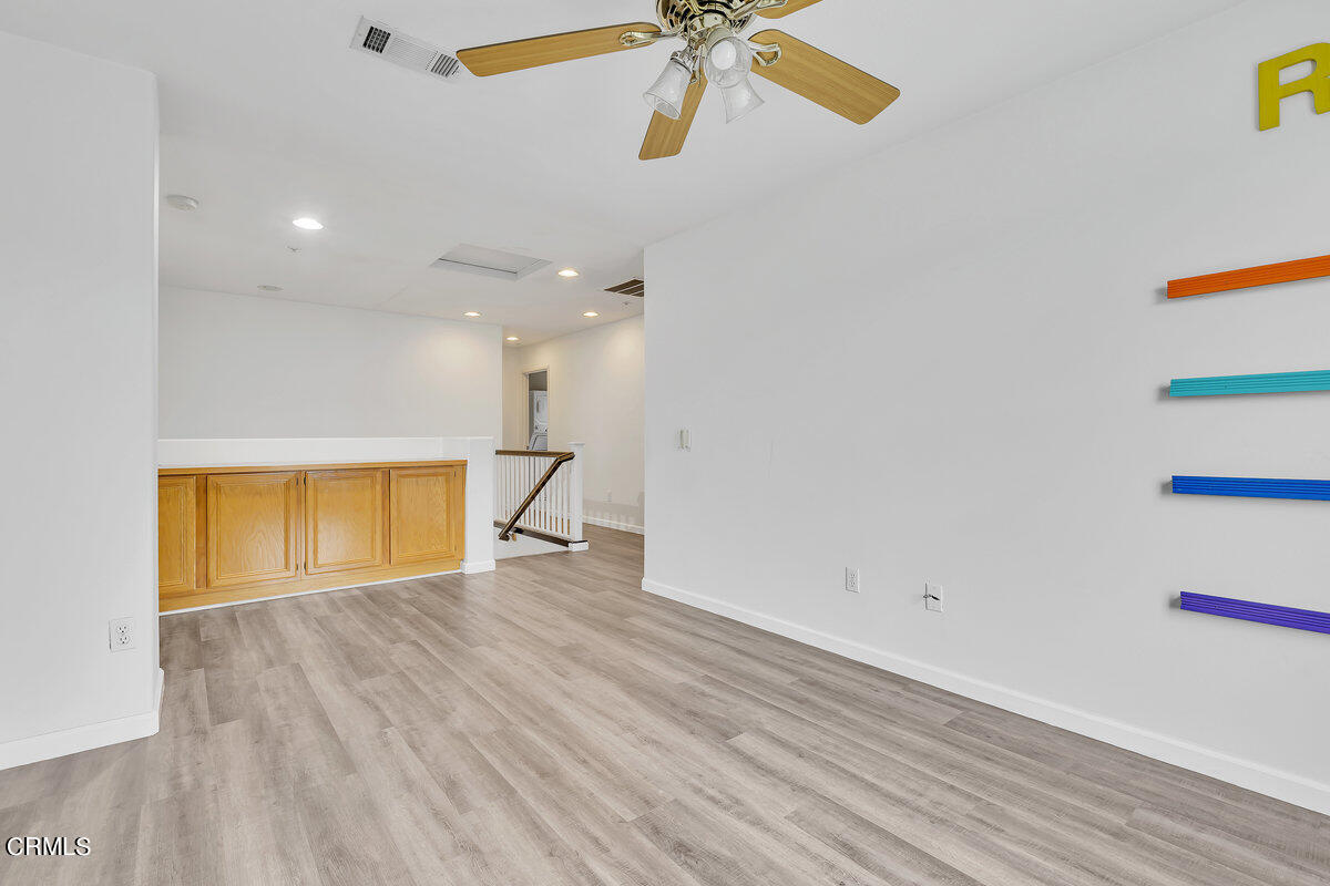 825 Noontide Way Oxnard, CA 93035 - Photo 13 of 26 a view of an empty room with wooden floor and a window