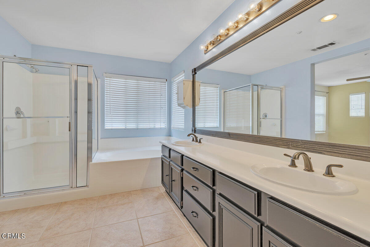 825 Noontide Way Oxnard, CA 93035 - Photo 16 of 26 a bathroom with a tub sink and mirror
