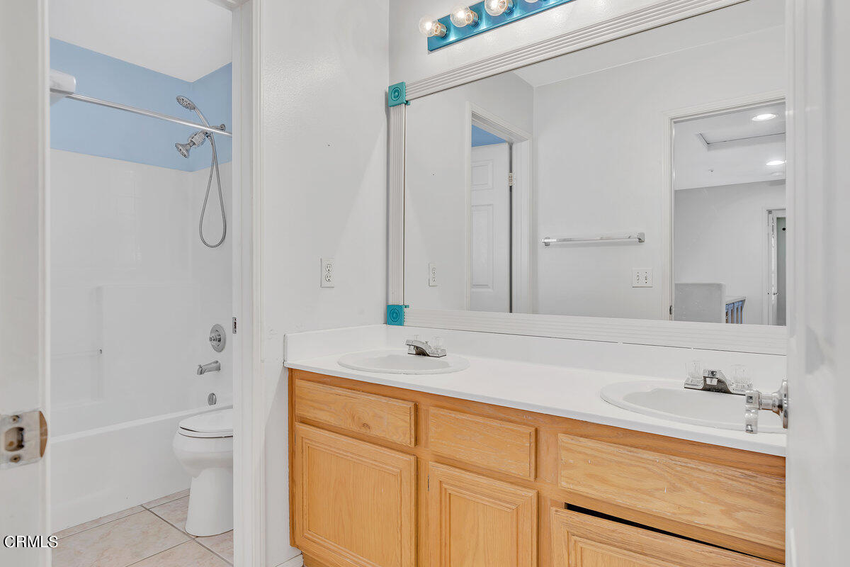 825 Noontide Way Oxnard, CA 93035 - Photo 19 of 26 a bathroom with a granite countertop sink a toilet and a bathtub