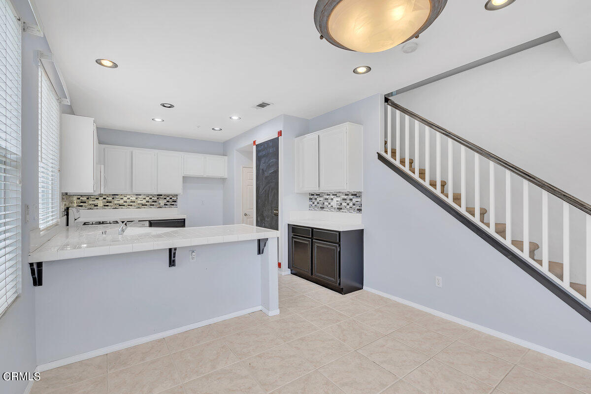 825 Noontide Way Oxnard, CA 93035 - Photo 7 of 26 a kitchen with stainless steel appliances granite countertop a sink and cabinets