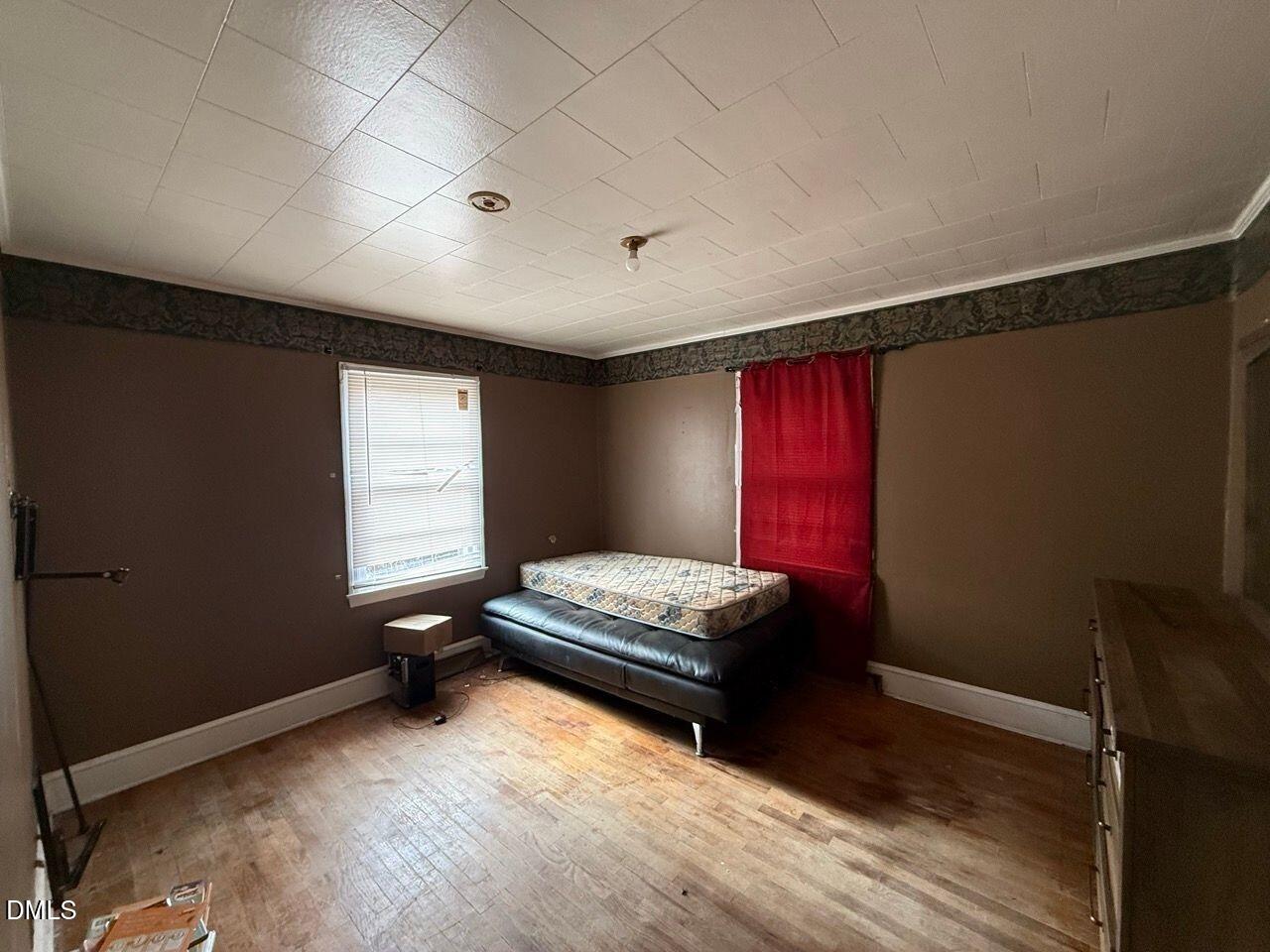 508 Jones Street Roxboro, NC 27573 - Photo 2 of 6 a bedroom with furniture and window