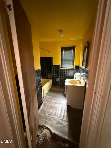 a view of bathroom with sink and mirror