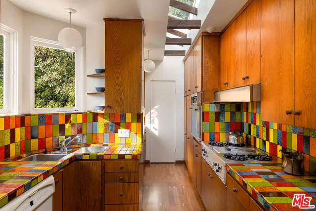 an entryway with wooden floor and windows