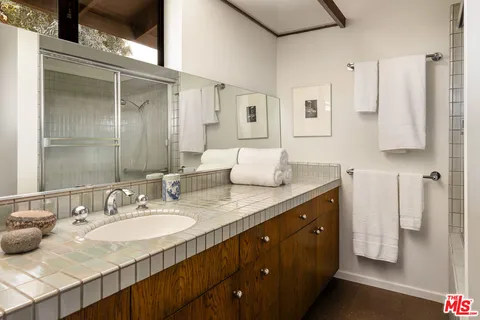 a bathroom with a granite countertop sink and a mirror